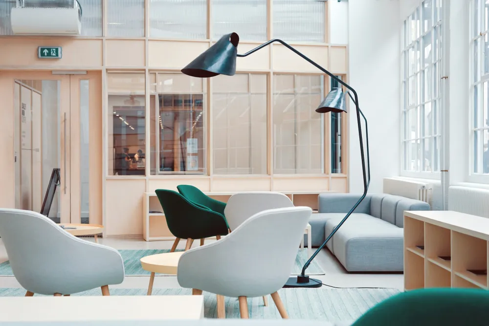 A bright, freshly decorated workspace lounge in Clerkenwell with pale walls and pastel chairs